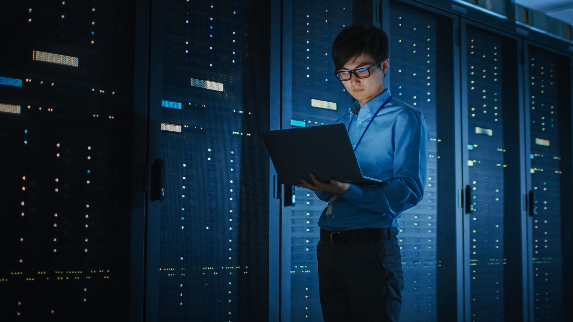 Man checking the laptop at the server room